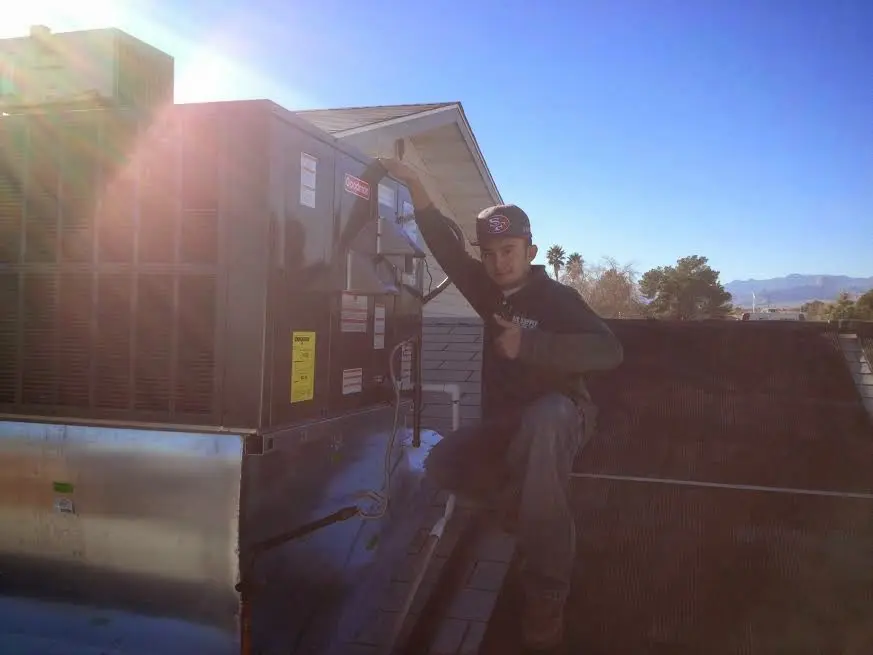 HVAC technician performing Boiler Repair on a rooftop unit in Westwego